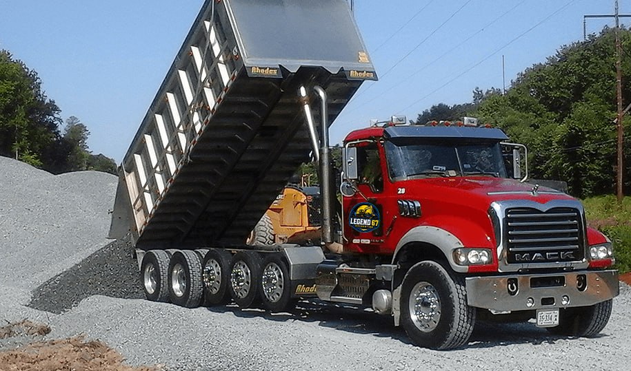Hauling truck delivering material